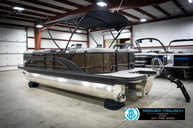 Slide: The Image of 2026 Bennington 21 SSR pontoon boat in indoor showroom, featuring sleek design and modern amenities. - 10