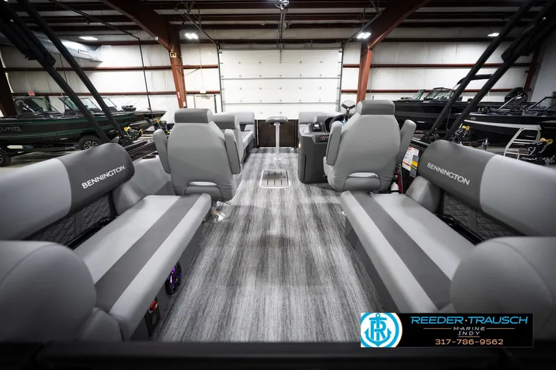 Slide: The Image of 2026 Bennington 21 SSR pontoon boat interior with gray seating in a showroom. - 19