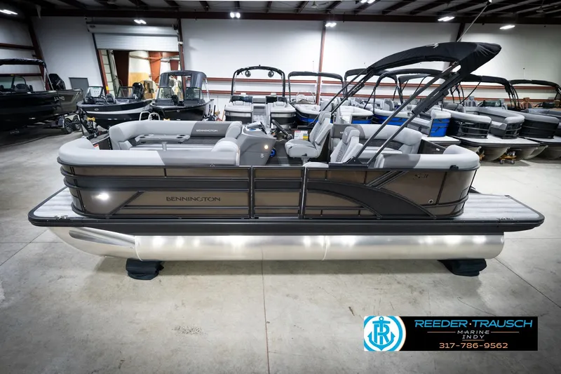 The Image of 2026 Bennington 21 SSR pontoon boat in showroom, featuring sleek design and modern seating. - 2