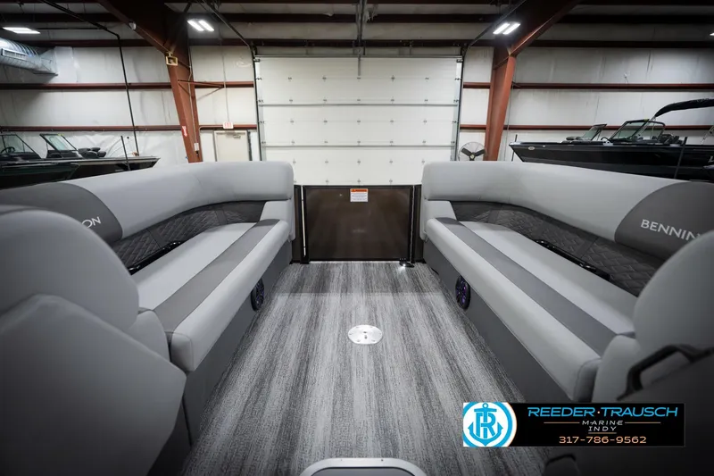 Slide: The Image of 2026 Bennington 21 SSR pontoon boat interior with gray seating in a showroom. - 22