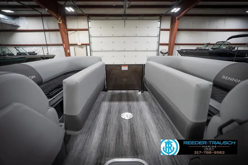 Slide: The Image of 2026 Bennington 21 SSR pontoon boat interior with gray seating in a showroom. - 23