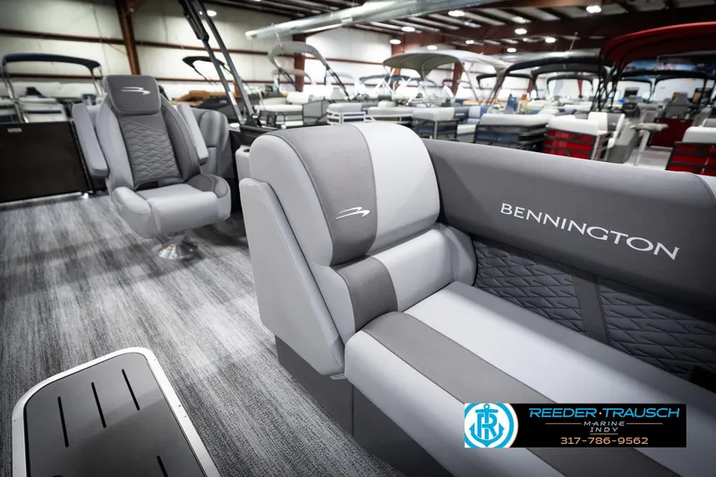 Slide: The Image of 2026 Bennington 21 SSR pontoon boat interior with gray seating in showroom. - 24