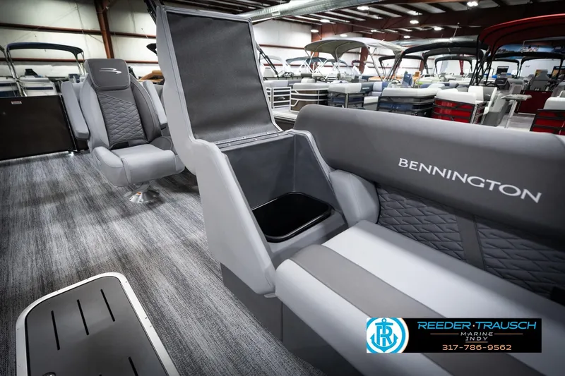 Slide: The Image of 2026 Bennington 21 SSR pontoon boat interior with gray seating and storage compartment. - 25