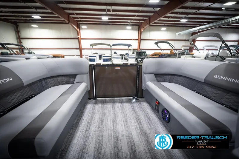 Slide: The Image of 2026 Bennington 21 SSR pontoon boat interior with gray seating in showroom. - 28