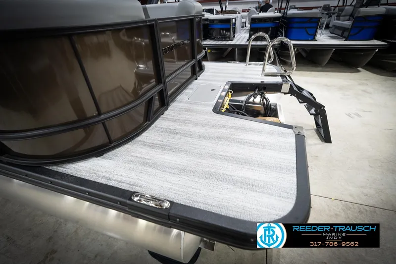 Slide: The Image of 2026 Bennington 21 SSR pontoon boat with sleek deck design at Reeder-Trausch Marine showroom. - 55