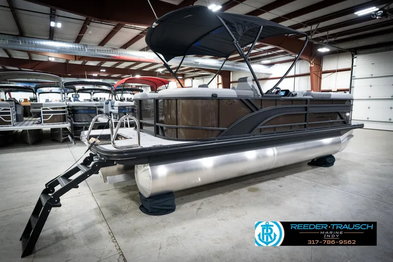 Slide: The Image of 2026 Bennington 21 SSR pontoon boat displayed indoors at Reeder Trausch Marine. - 8