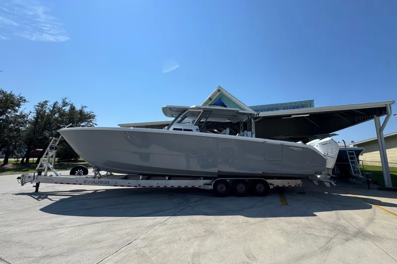 Slide: The Image of 2026 Invincible 40 Catamaran on trailer under clear blue sky. - 1