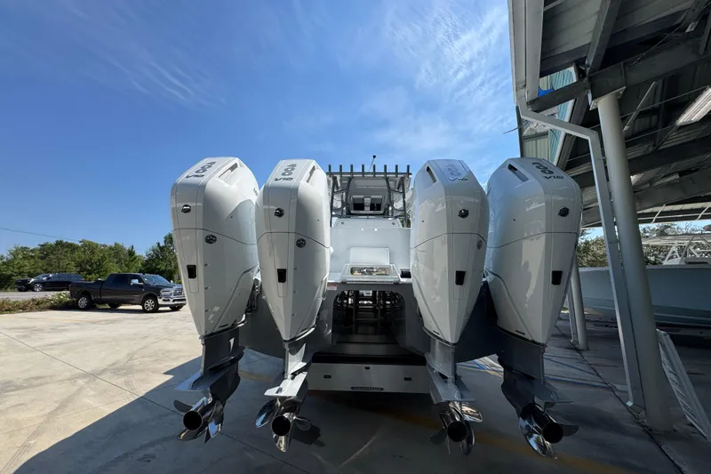 Slide: The Image of 2026 Invincible 40 Catamaran with quad outboard engines under a clear blue sky. - 14