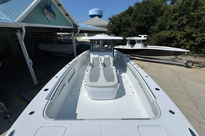 Slide: The Image of 2026 Invincible 40 Catamaran docked, showcasing spacious deck and seating area. - 19