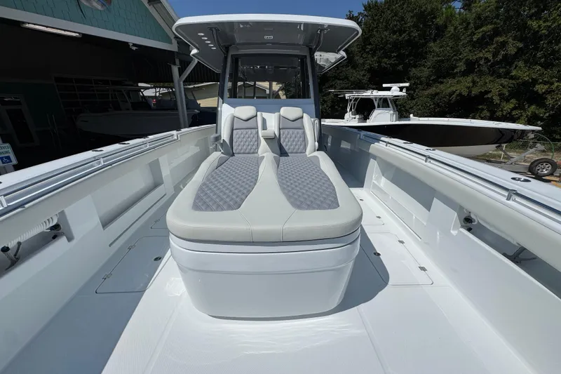 Slide: The Image of 2026 Invincible 40 Catamaran with sleek seating and modern design in a marina setting. - 20