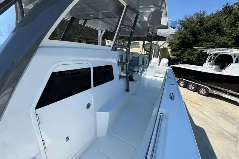 Slide: The Image of 2026 Invincible 40 Catamaran, sleek design, spacious deck, modern features, parked outdoors. - 21