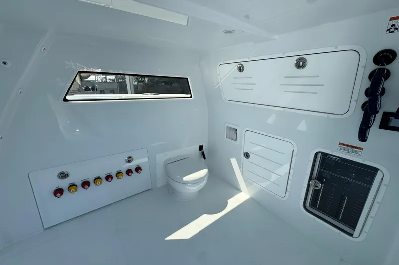 Slide: The Image of Interior of 2026 Invincible 40 Catamaran featuring control panel and marine toilet. - 23