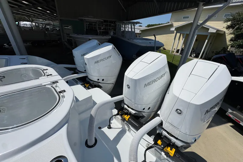 Slide: The Image of 2026 Invincible 40 Catamaran with four Mercury outboard engines in a covered storage area. - 38