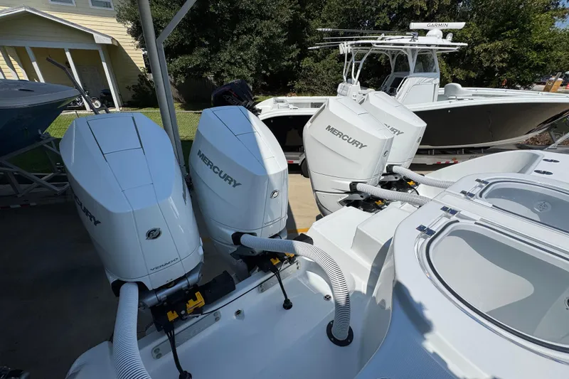 Slide: The Image of 2026 Invincible 40 Catamaran with Mercury engines, docked outdoors. - 39