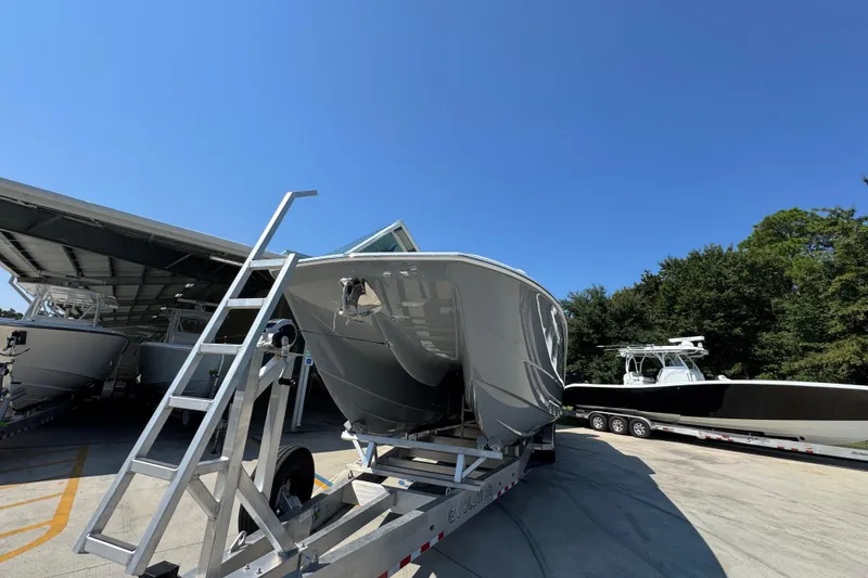 Slide: The Image of 2026 Invincible 40 Catamaran on trailer under clear blue sky. - 6