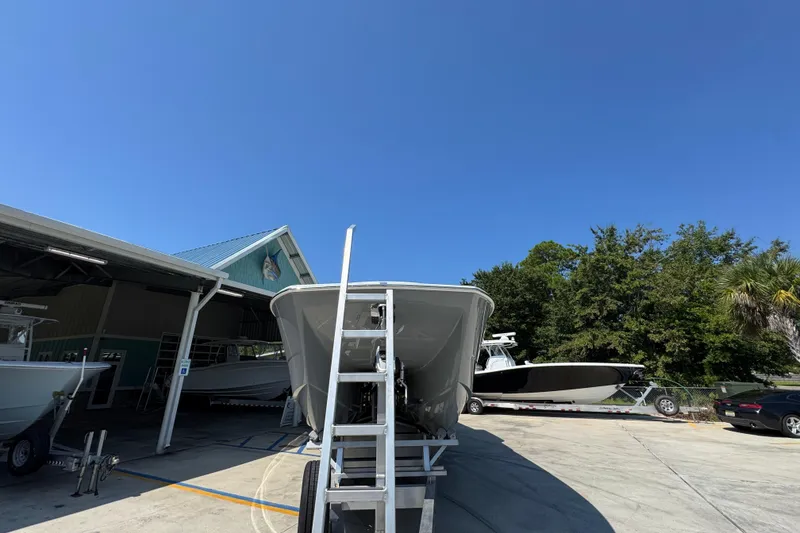 Slide: The Image of 2026 Invincible 40 Catamaran in boatyard under clear blue sky. - 7