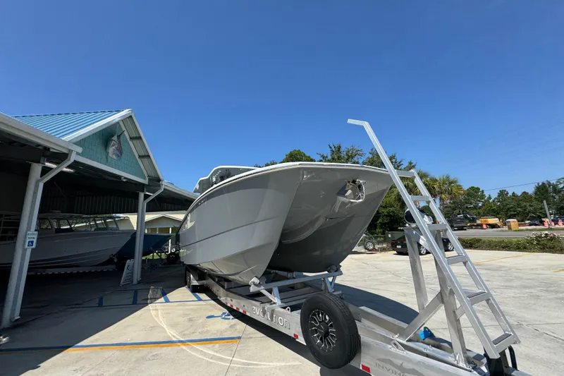 Slide: The Image of 2026 Invincible 40 Catamaran on trailer under clear blue sky. - 8