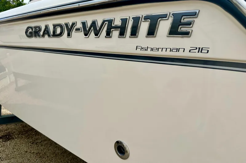 Slide: The Image of 2026 Grady-White Fisherman 216 boat side view with logo and model name. - 2