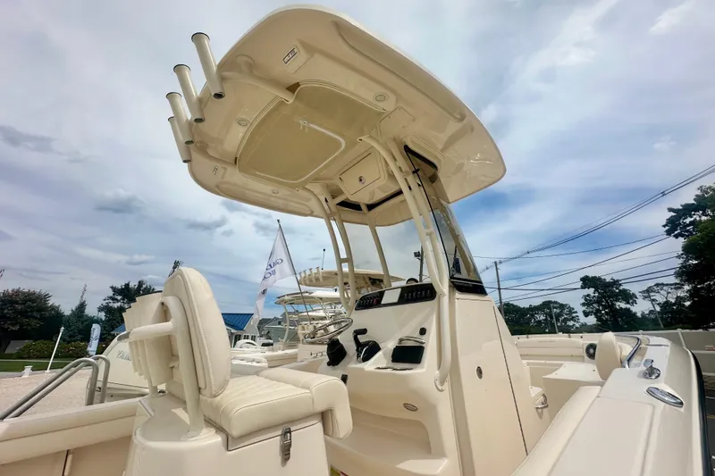 Slide: The Image of 2026 Grady-White Fisherman 216 boat, featuring a sleek console and seating under a cloudy sky. - 4