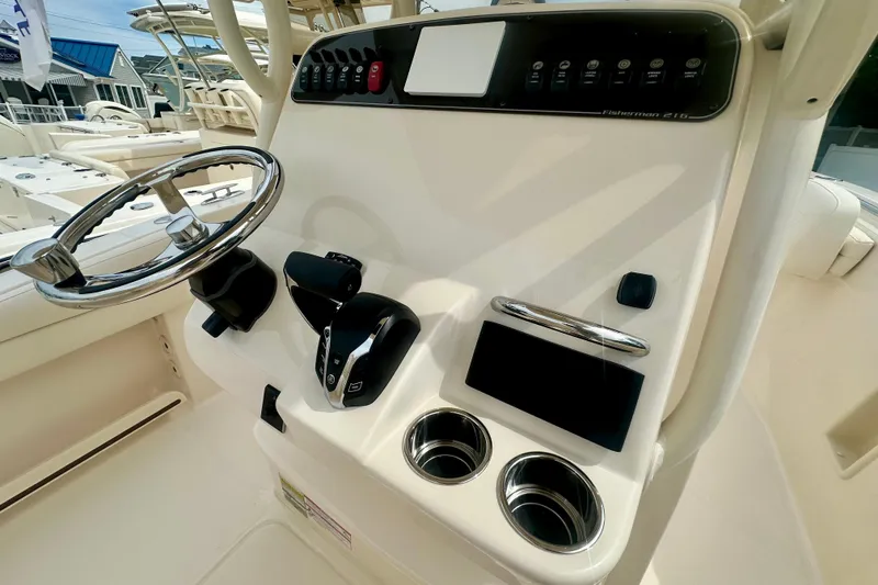 Slide: The Image of 2026 Grady-White Fisherman 216 boat console with steering wheel and controls. - 8