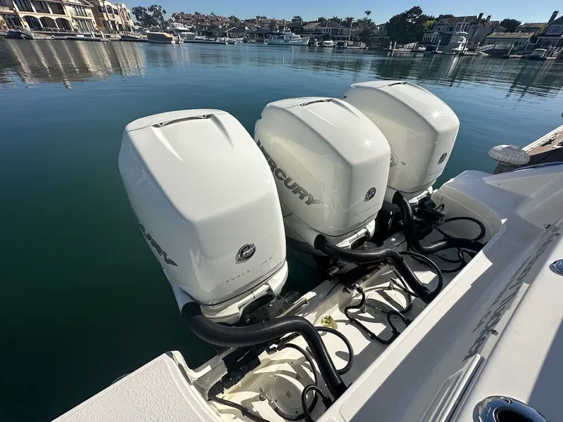 Slide: The Image of 2019 Boston Whaler 350 Realm with triple Mercury outboard engines docked in marina. - 21