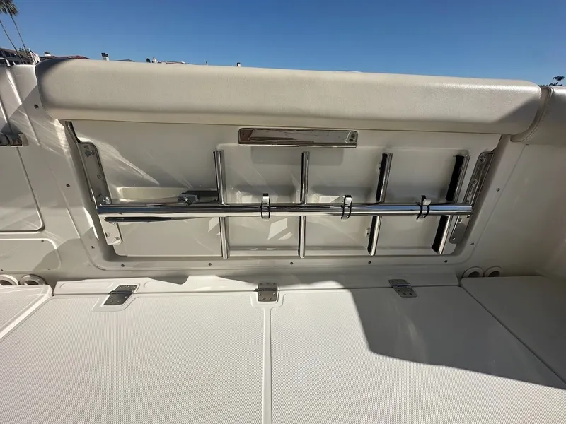 Slide: The Image of 2019 Boston Whaler 350 Realm interior with rod holders and cushioned seating. - 22