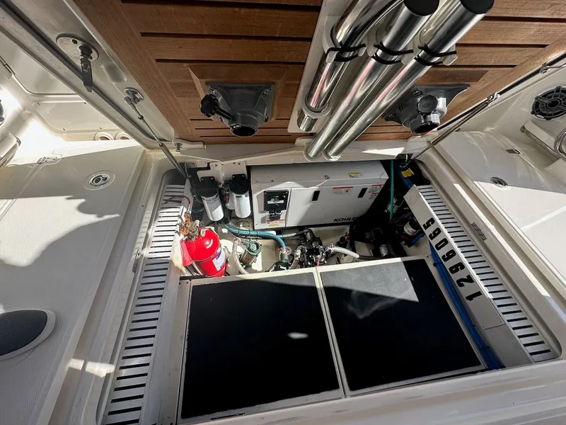 Slide: The Image of Engine compartment of 2019 Boston Whaler 350 Realm with equipment and fire extinguisher. - 23