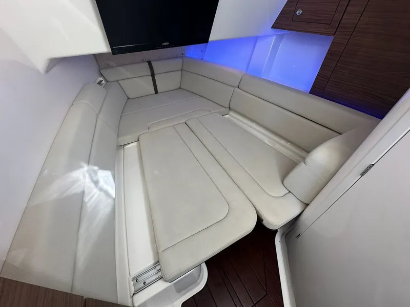 Slide: The Image of Interior cabin of 2019 Boston Whaler 350 Realm with white seating and ambient lighting. - 27