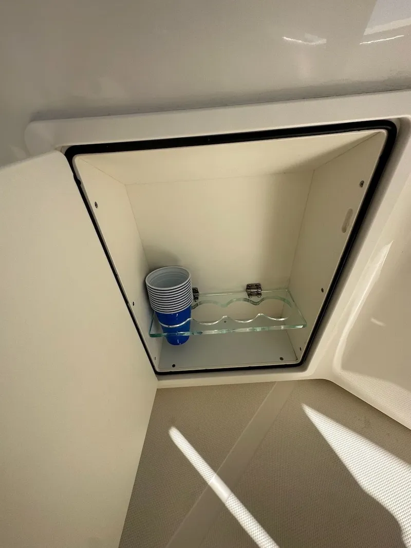 Slide: The Image of Storage compartment with cups on a 2019 Boston Whaler 350 Realm boat. - 32