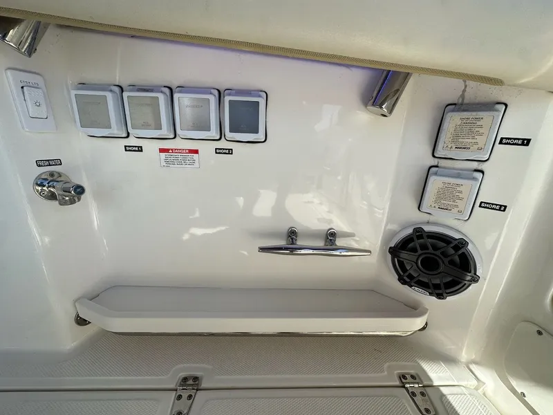 Slide: The Image of 2019 Boston Whaler 350 Realm boat control panel with switches and speaker. - 36