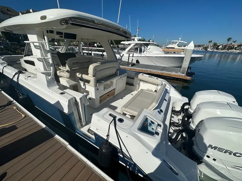 Slide: The Image of 2019 Boston Whaler 350 Realm boat docked with triple Mercury engines. - 4
