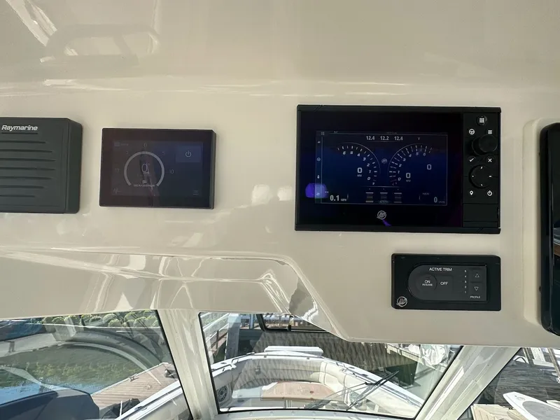 Slide: The Image of 2019 Boston Whaler 350 Realm dashboard with Raymarine displays and controls. - 9