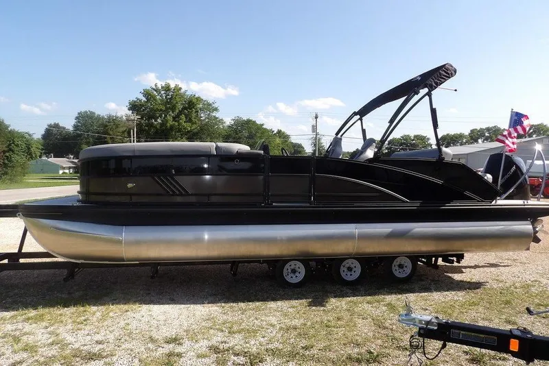 The Image of 2026 Bennington M Swingback 24 MSB pontoon boat displayed outdoors. - 0