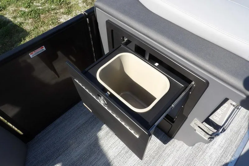 Slide: The Image of 2026 Bennington M Swingback 24 MSB boat storage compartment with open drawer and bin. - 18