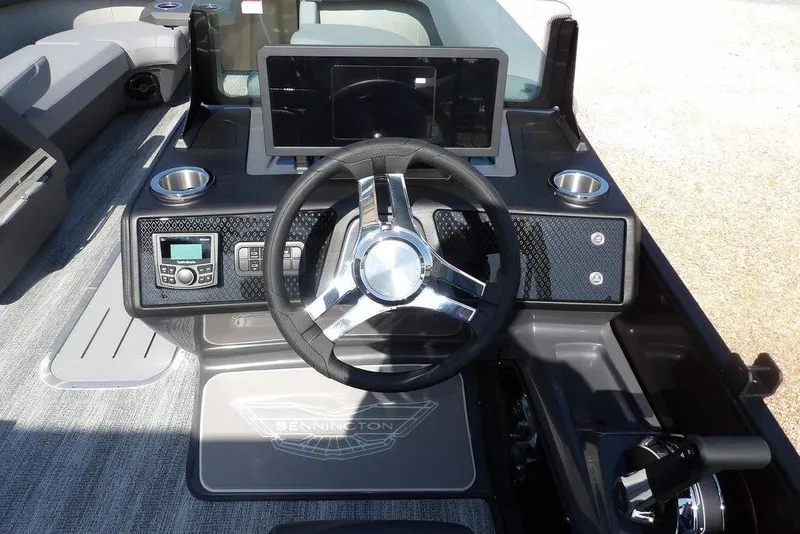 Slide: The Image of 2026 Bennington M Swingback 24 MSB boat dashboard with steering wheel and control panel. - 21