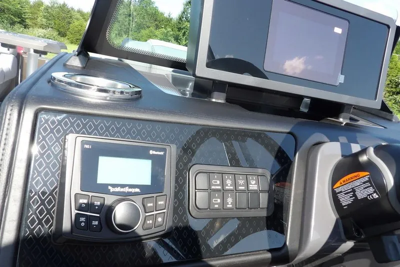 Slide: The Image of 2026 Bennington M Swingback 24 MSB dashboard with control panel and display screen. - 27