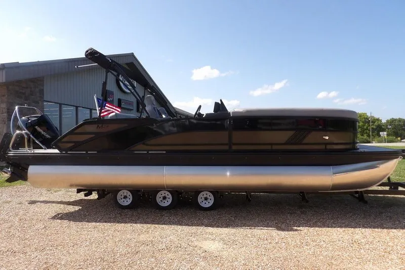 Slide: The Image of 2026 Bennington M Swingback 24 MSB pontoon boat on a trailer, outdoors. - 4