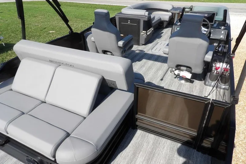 Slide: The Image of 2026 Bennington M Swingback 24 MSB pontoon boat interior with gray seating and modern controls. - 41