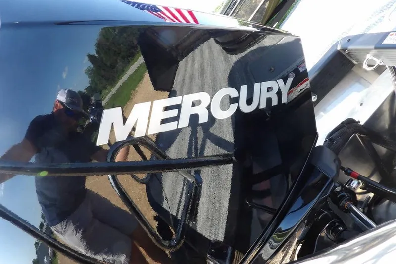 Slide: The Image of Mercury engine on 2026 Bennington M Swingback 24 MSB boat, reflecting surroundings. - 42