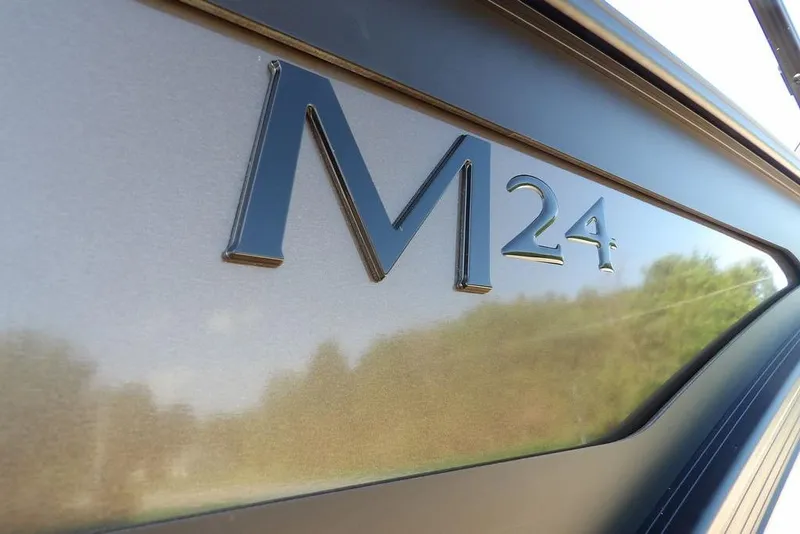 Slide: The Image of Close-up of 2026 Bennington M Swingback 24 MSB logo on sleek metallic surface. - 43