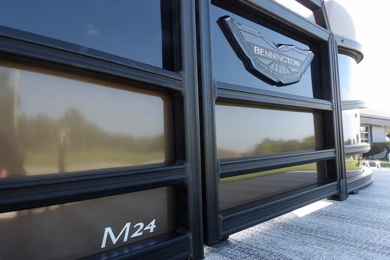 Slide: The Image of 2026 Bennington M Swingback 24 MSB pontoon boat, sleek design with "M24" marking. - 44
