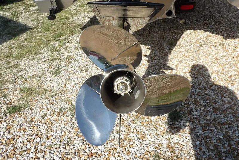 Slide: The Image of 2026 Bennington M Swingback 24 MSB boat propeller on gravel surface. - 48