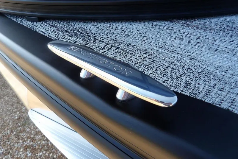 Slide: The Image of Close-up of a 2026 Bennington M Swingback 24 MSB boat cleat on textured surface. - 49