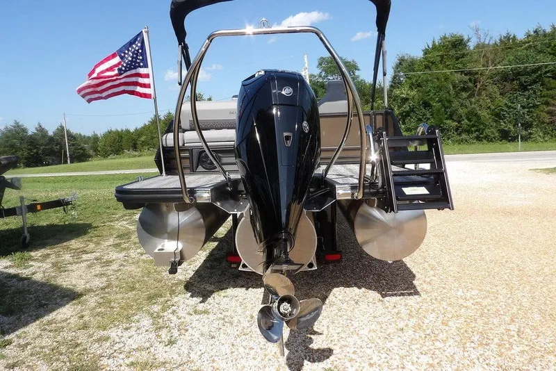 Slide: The Image of 2026 Bennington M Swingback 24 MSB pontoon boat with American flag, rear view. - 6