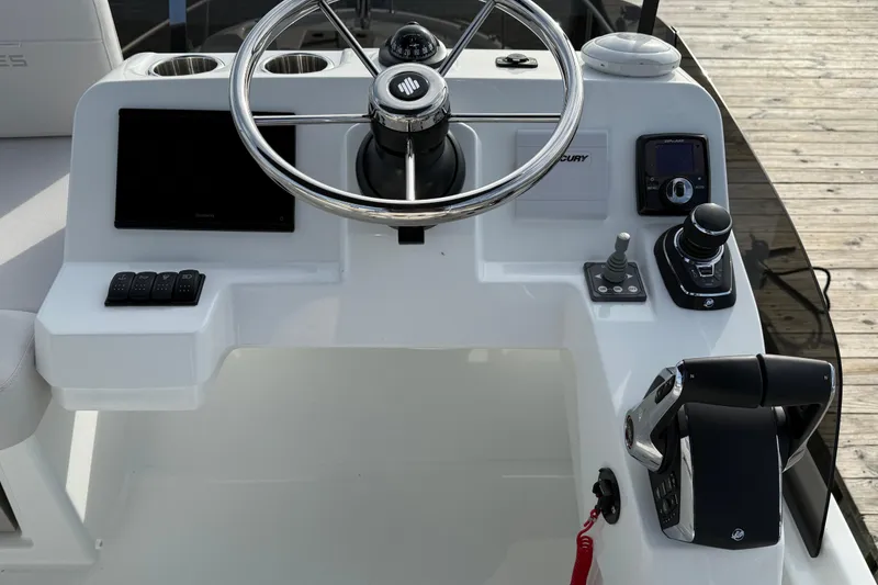 Slide: The Image of Steering console of 2026 Beneteau Antares 11 Fly with modern controls and navigation equipment. - 10