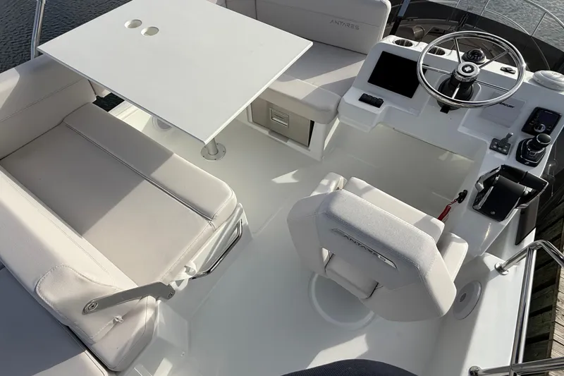 Slide: The Image of 2026 Beneteau Antares 11 Fly cockpit with helm, seating, and table. - 11