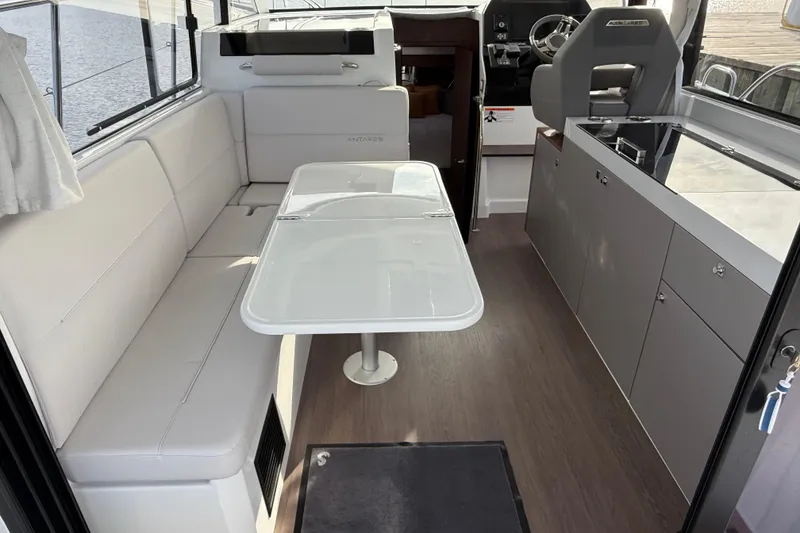 Slide: The Image of Interior of 2026 Beneteau Antares 11 Fly, featuring modern seating and dining area. - 13