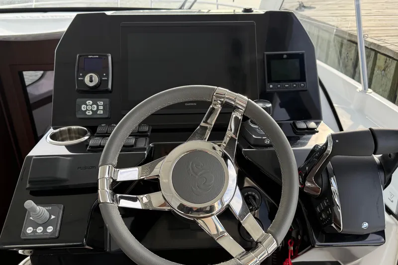 Slide: The Image of Steering console of 2026 Beneteau Antares 11 Fly with modern controls and displays. - 14