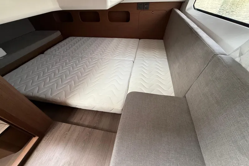 Slide: The Image of Interior cabin of 2026 Beneteau Antares 11 Fly with cozy mattress and seating. - 16