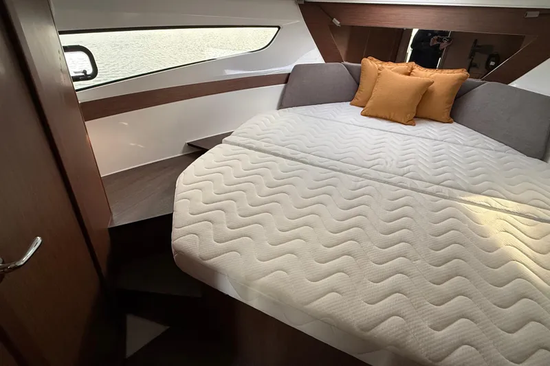 Slide: The Image of Luxurious cabin interior of 2026 Beneteau Antares 11 Fly with cozy bedding and cushions. - 22